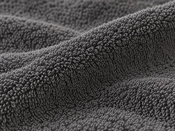 Close-up of dense dark gray cotton terry loops.