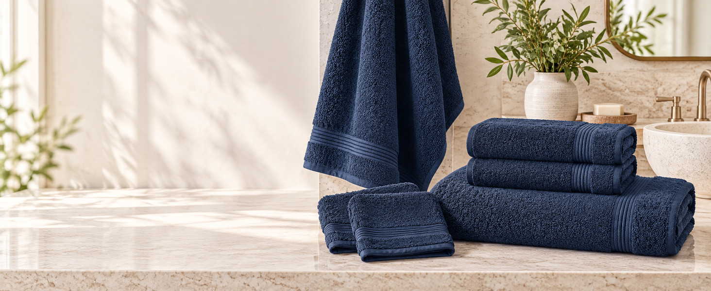 Navy 6-piece towel set with bath towels, hand towels, and washcloths on a stone vanity.